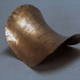 Brass plates of constant negative curvature